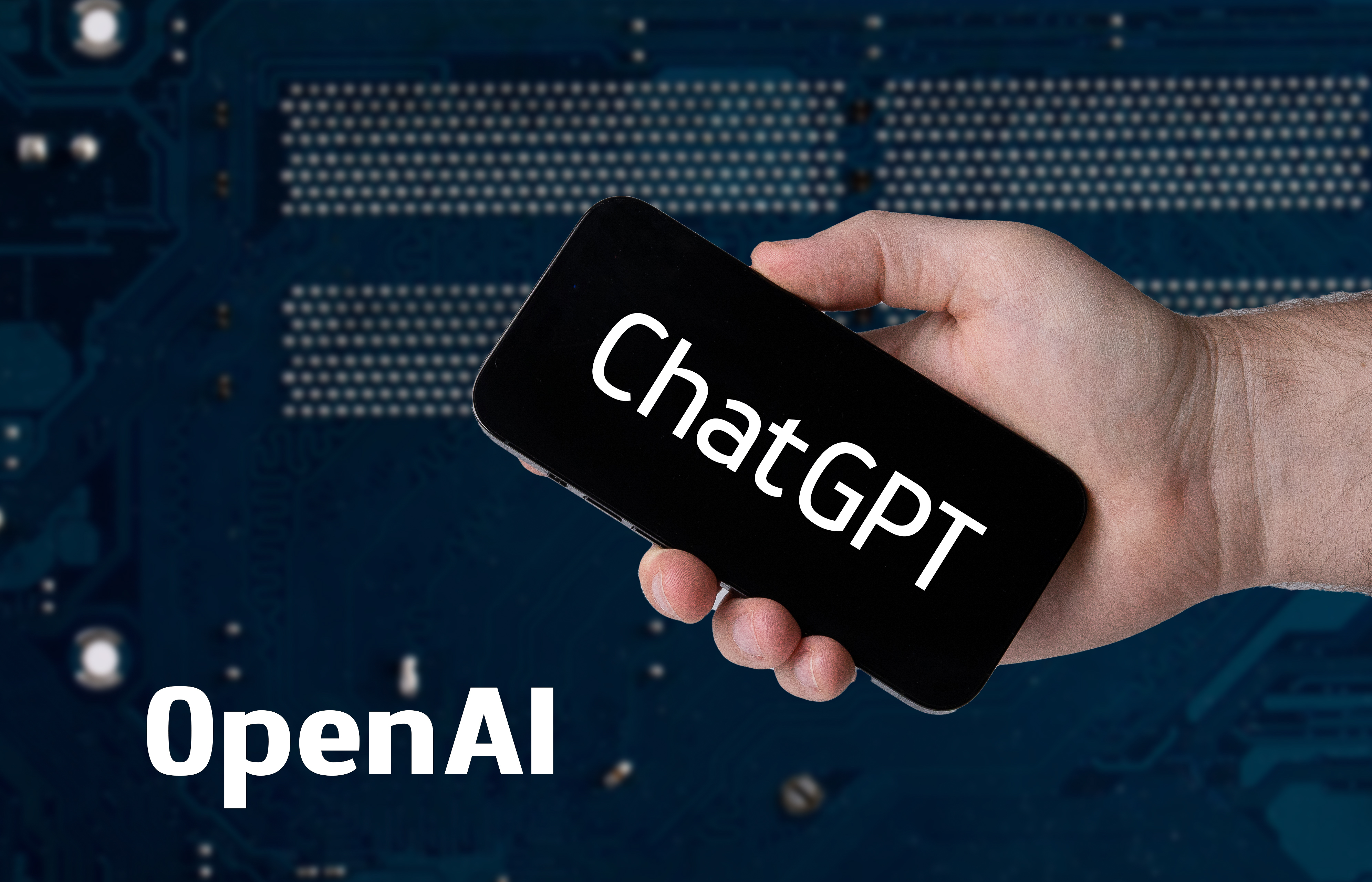 Hand_holding_smartphone_with_ChatGPT_and_OpenAI_text_52917312010.jpg